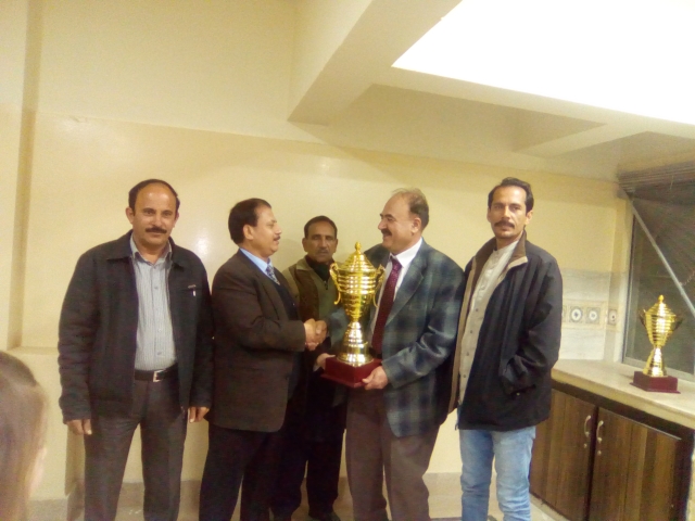 L-R Mr. Ishtiaq Ch. IM Lodhi Receiving Trophy Mr. Ghulam Abbas President CAP Mr. Abdul Aziz Khan President BCA presenting Trophy Mr. Waqar Ahmad Madni General Secretary Chess Federation of Pakistan