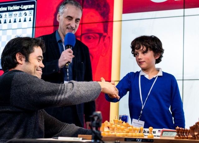 Hikaru Nakamura shakes hands with Alex